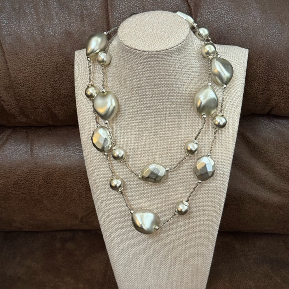 Featuring large silver faux pearls & silver shaped beads on thin wire or cord.